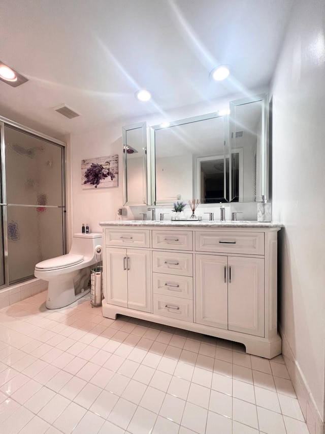 bathroom featuring a shower with door, tile patterned floors, vanity, and toilet