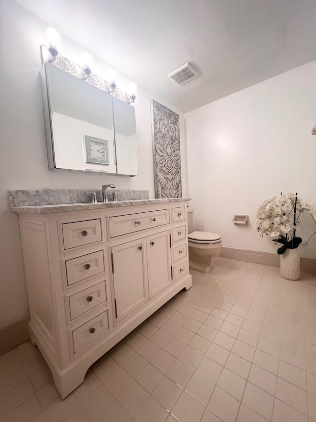 bathroom with tile patterned floors, vanity, and toilet