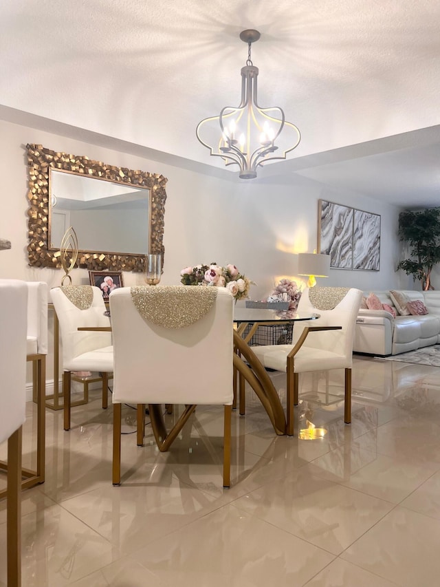 dining space featuring a chandelier and a textured ceiling