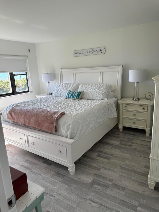 bedroom with dark hardwood / wood-style floors