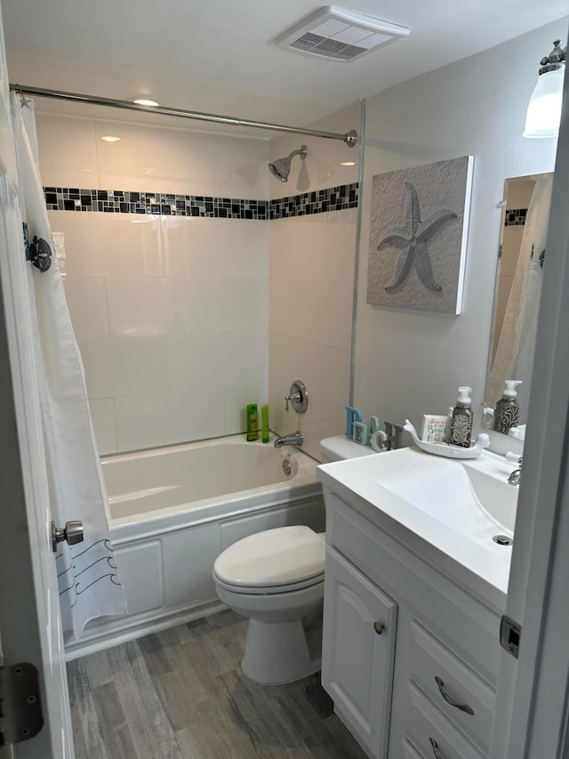 full bathroom featuring wood-type flooring, vanity, toilet, and shower / bathtub combination with curtain