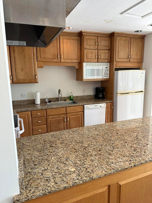 kitchen with light stone counters, sink, white appliances, a textured ceiling, and ventilation hood