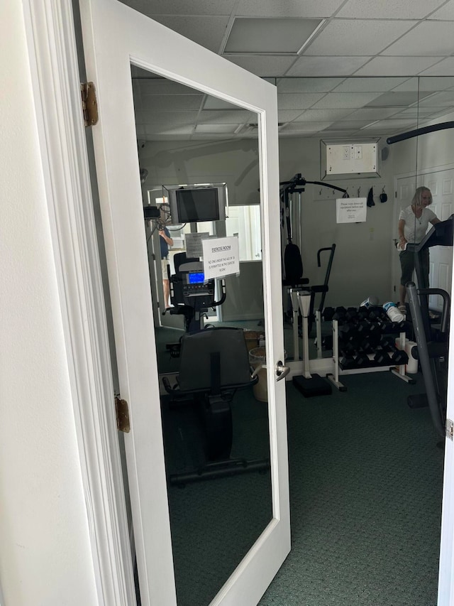 workout room with carpet and a paneled ceiling