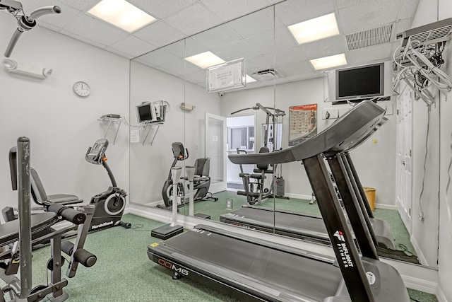 exercise room featuring a paneled ceiling