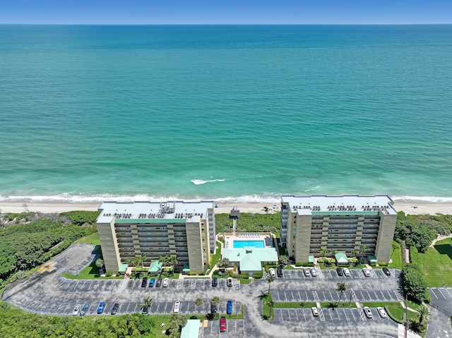 bird's eye view with a water view and a beach view