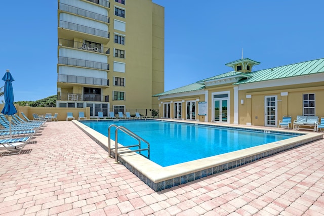 view of swimming pool featuring a patio area