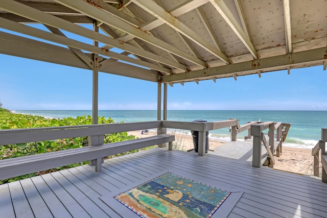 wooden deck with a view of the beach and a water view