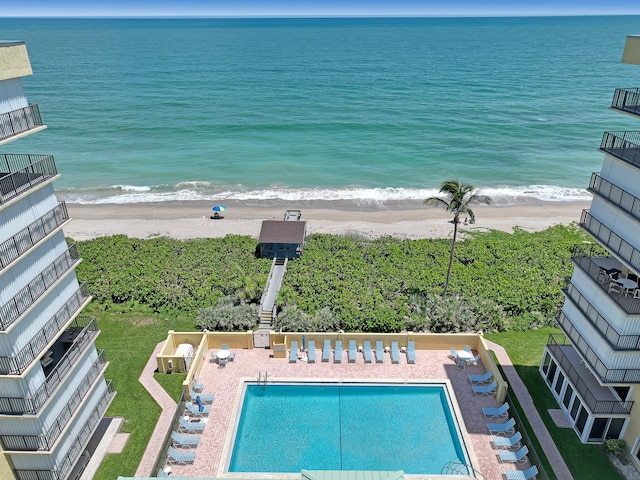 birds eye view of property featuring a water view and a beach view