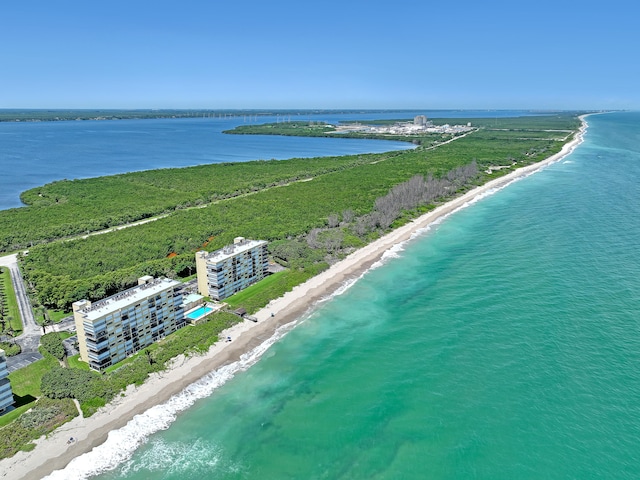 birds eye view of property featuring a beach view and a water view