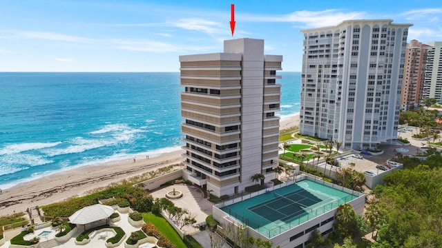 exterior space featuring a water view and a beach view