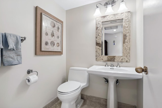 bathroom with toilet and tile patterned flooring