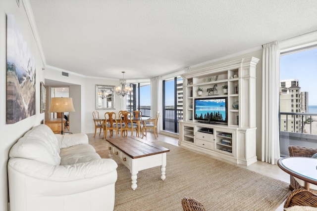 living room featuring crown molding, a notable chandelier, and a textured ceiling