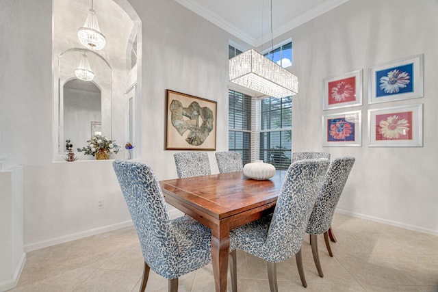 dining room featuring a towering ceiling, ornamental molding, light tile patterned flooring, and a notable chandelier