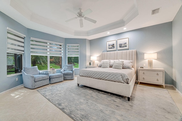 bedroom featuring ceiling fan, light tile patterned floors, a tray ceiling, and ornamental molding