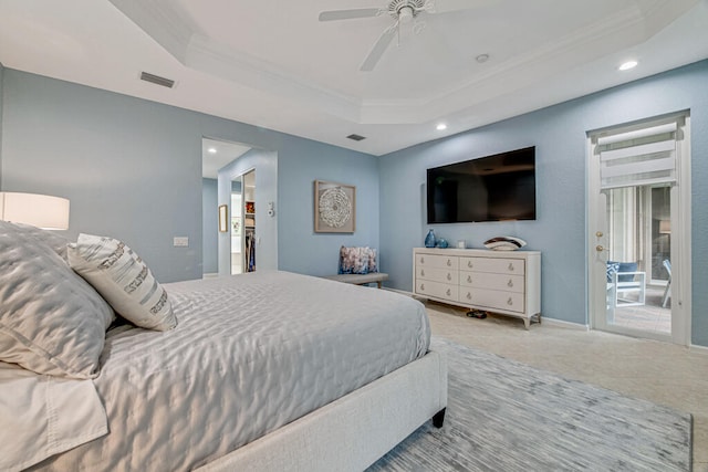 bedroom featuring a raised ceiling, ornamental molding, and ceiling fan