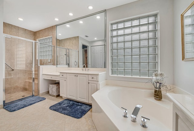 bathroom with independent shower and bath, vanity, and tile patterned flooring