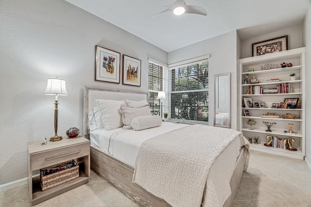 tiled bedroom featuring ceiling fan