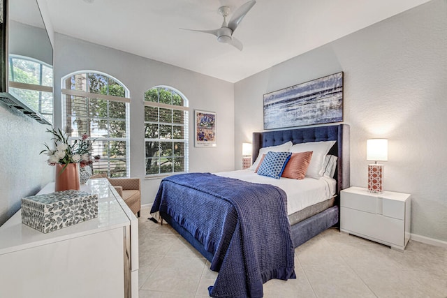 bedroom featuring light tile patterned flooring and ceiling fan