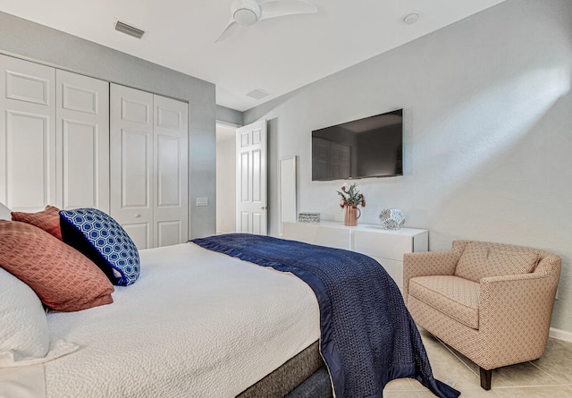 bedroom featuring ceiling fan, a closet, and light tile patterned floors