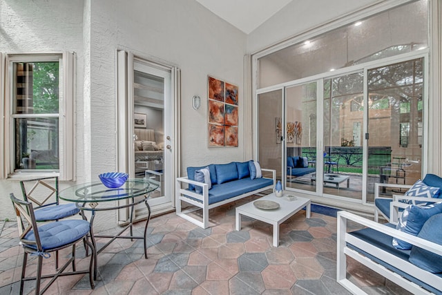 sunroom / solarium featuring lofted ceiling