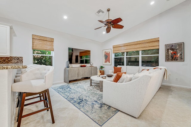 living room featuring lofted ceiling, ceiling fan, and light tile patterned floors