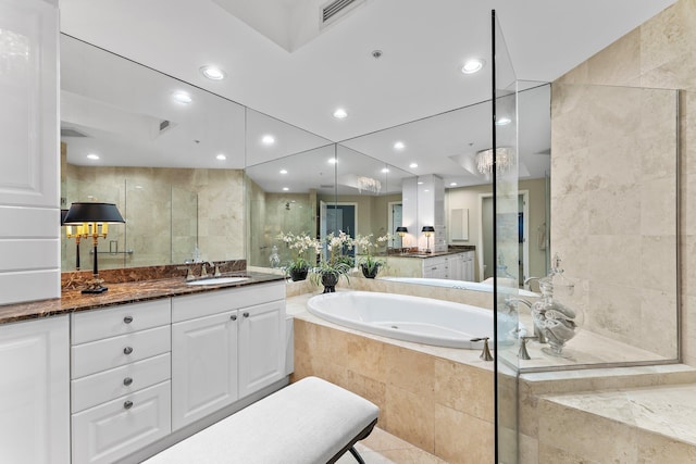 bathroom featuring vanity and shower with separate bathtub