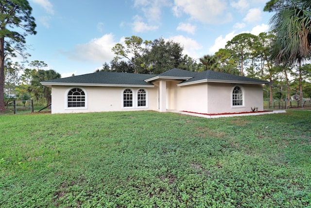 back of house with a lawn