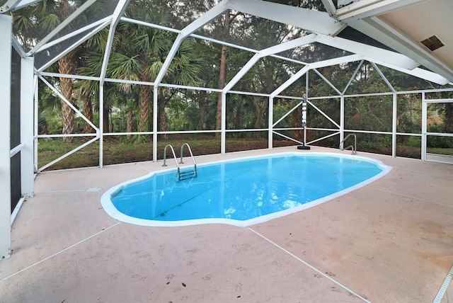 view of pool featuring a lanai and a patio