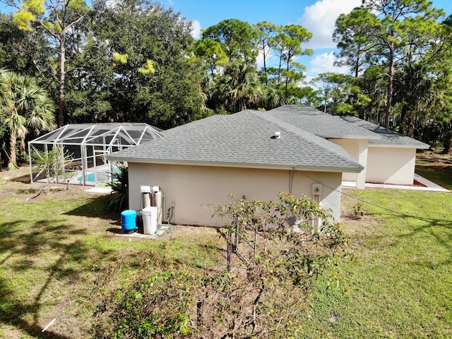 view of property exterior featuring a lawn and a lanai