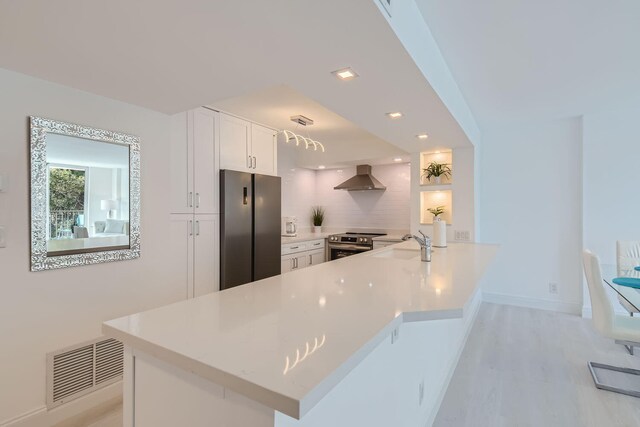 dining space with light wood-type flooring and sink