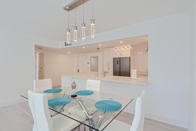 dining room with light wood-type flooring and expansive windows