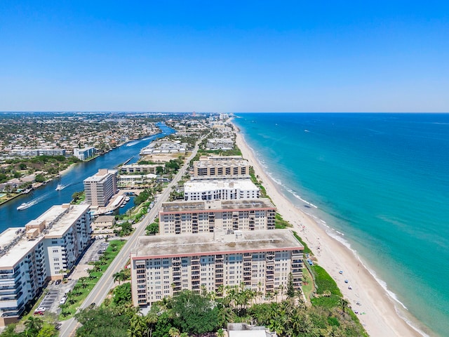 bird's eye view with a water view and a beach view