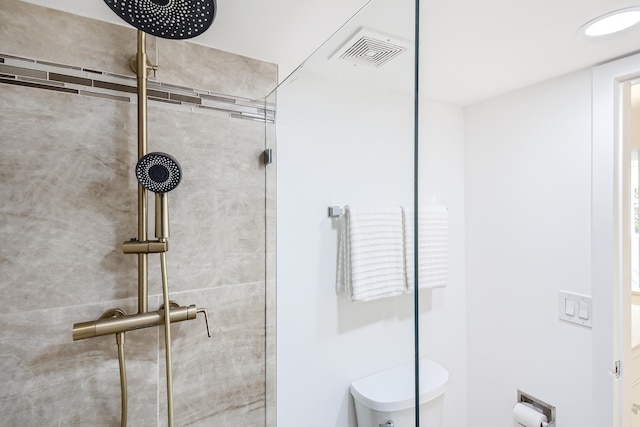 bathroom featuring toilet and walk in shower