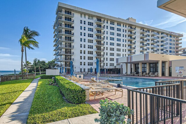 birds eye view of property with a water view and a beach view