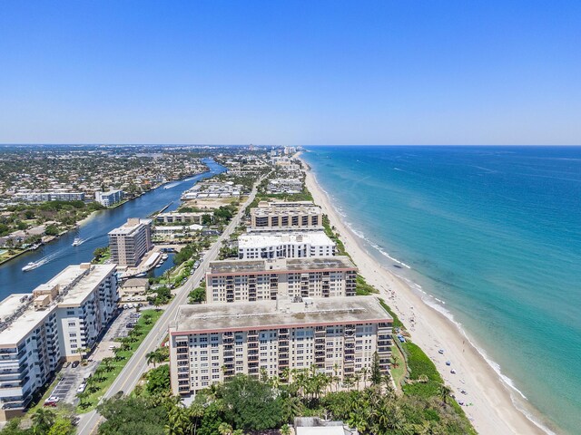 drone / aerial view featuring a view of the beach and a water view