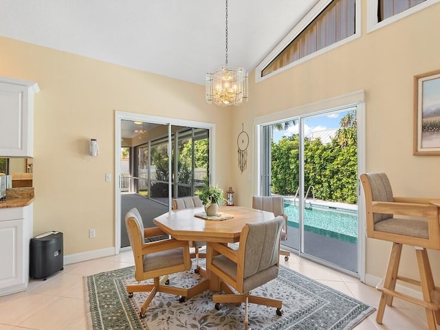 tiled dining area with lofted ceiling and a chandelier