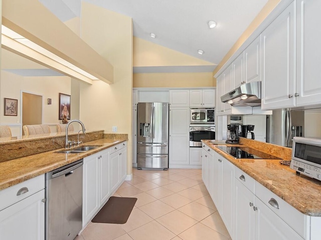 kitchen featuring vaulted ceiling, sink, white cabinets, stainless steel appliances, and light stone countertops