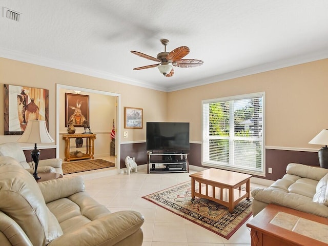 living room featuring light tile patterned floors, crown molding, and ceiling fan