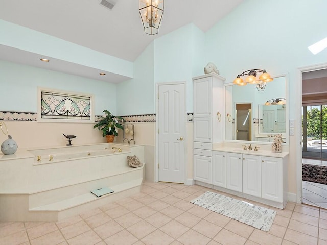 bathroom with high vaulted ceiling, a tub, a chandelier, tile patterned flooring, and vanity