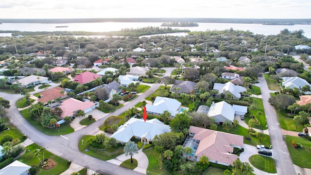 birds eye view of property with a water view