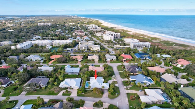 birds eye view of property with a view of the beach and a water view