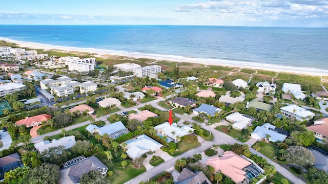 birds eye view of property with a beach view and a water view