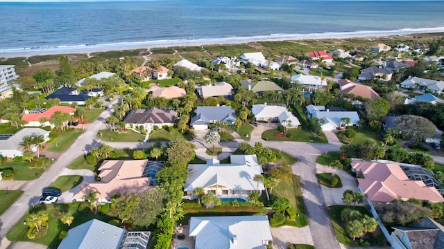 aerial view with a water view and a beach view