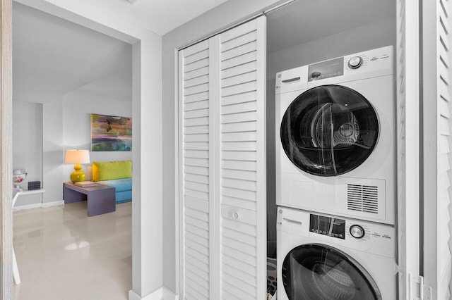 laundry area with stacked washer / drying machine