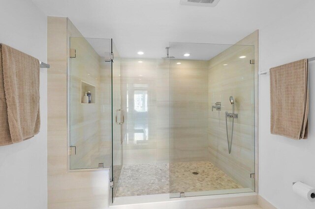 bathroom with a bidet, vanity, tile patterned flooring, a shower with shower door, and toilet