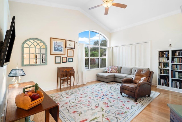 living room with light wood-type flooring, crown molding, lofted ceiling, and ceiling fan