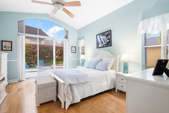 bedroom featuring ceiling fan, light hardwood / wood-style flooring, vaulted ceiling, and access to outside