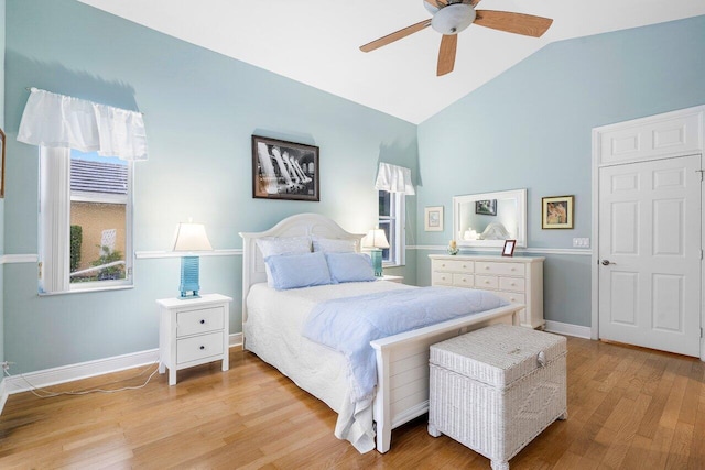 bedroom featuring light wood-type flooring, lofted ceiling, and ceiling fan