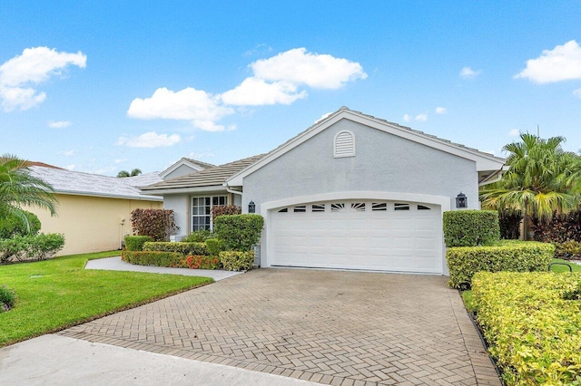 ranch-style house with a garage and a front yard