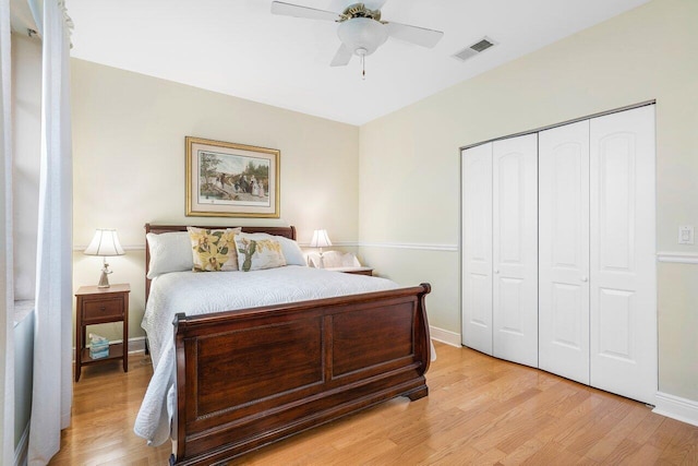 bedroom with light hardwood / wood-style floors, ceiling fan, and a closet